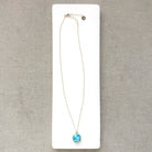 Small Golden Hills pendant set in sterling silver in a white dish