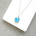 Small Golden Hills pendant set in sterling silver in a white dish