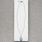 A Golden Hills turquoise pendant necklace on a white card.
