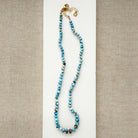 Golden Hills Turquoise knotted necklace on a white plate