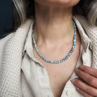 Close up of woman wearing Golden Hills Turquoise knotted necklace