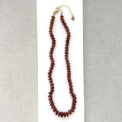 Hessonite garnet necklace on a white plate
