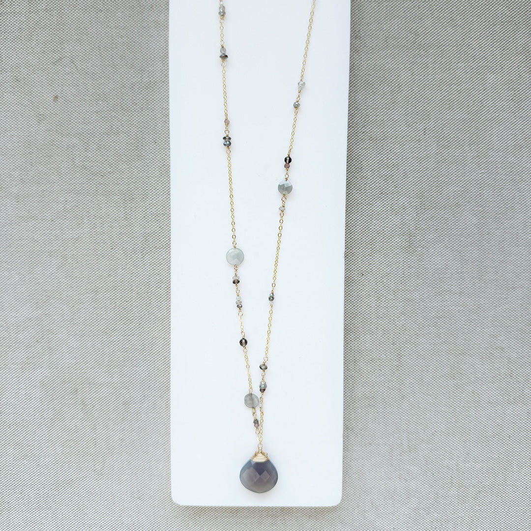 Long necklace with gray moonstone pendant on a white background