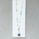 Long necklace with gray moonstone pendant on a white background