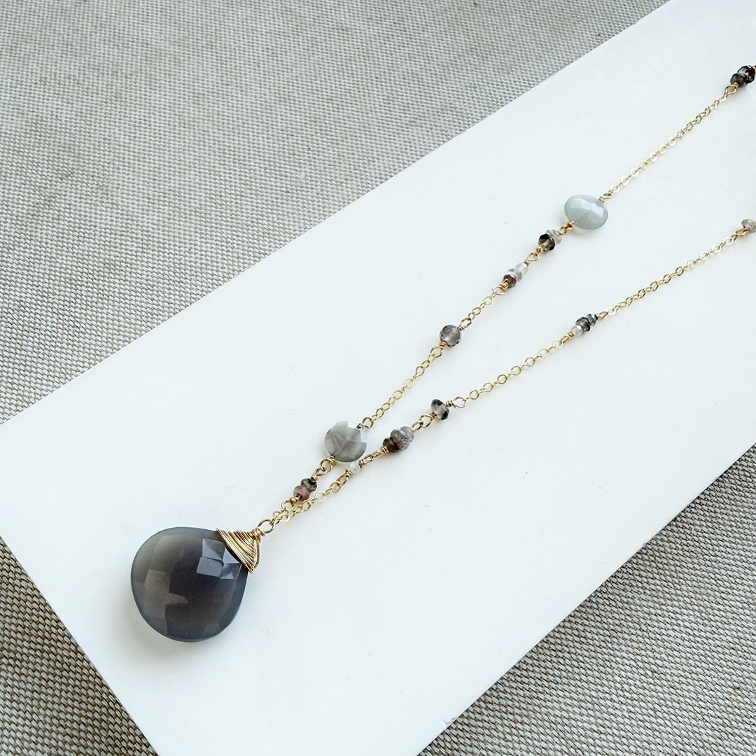 Long necklace with gray moonstone pendant on a white background