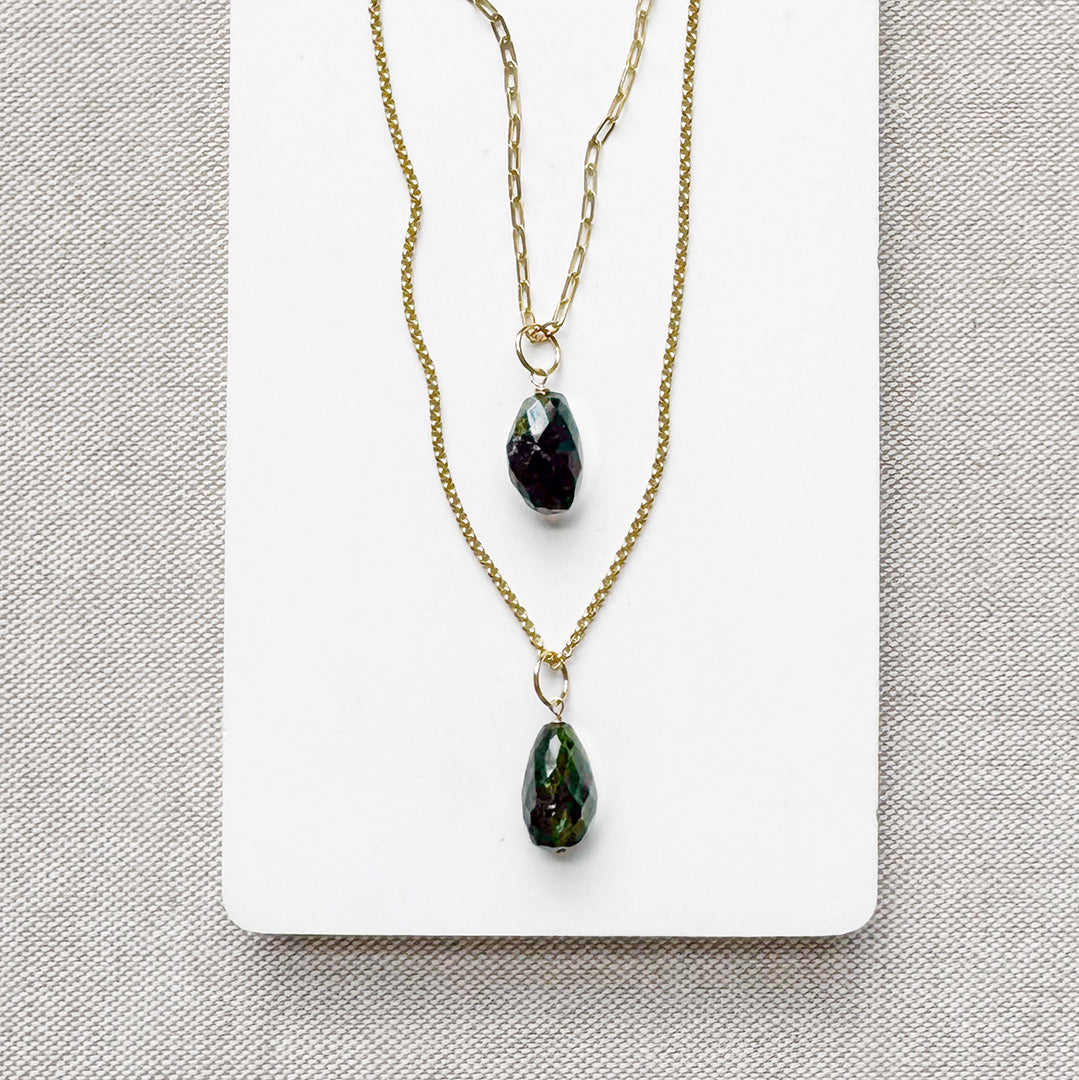 Two gold chains with large green tourmaline gemstone charms