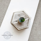 Ring with a green tourmaline gemstone in a hexagonal box and one of a kind branding