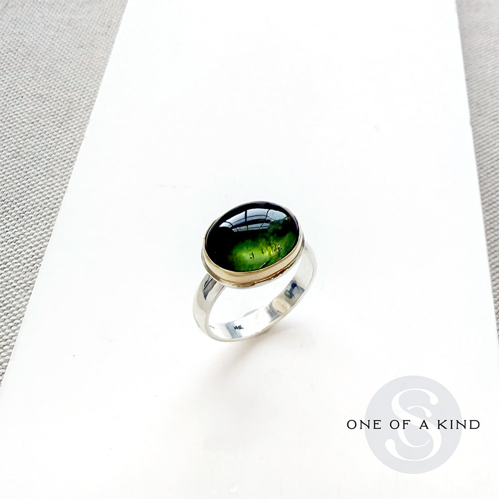 Green Tourmaline mixed metal ring on a white background
