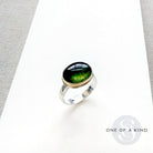 Green Tourmaline mixed metal ring on a white background