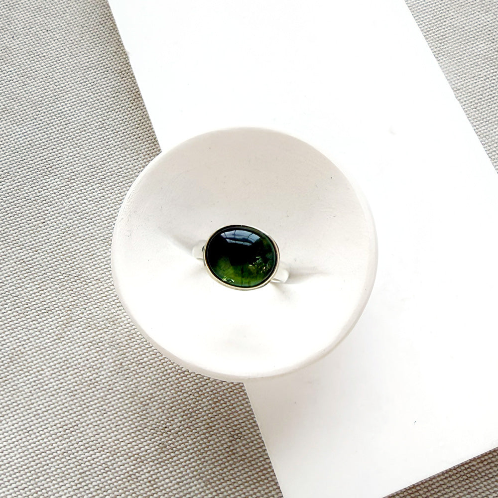 Green Tourmaline mixed metal ring on a white background