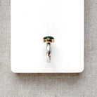 Green Tourmaline mixed metal ring on a white background