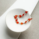 Bracelet with carnelian gemstones in a white dish