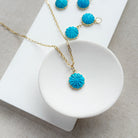 Small carved howlite flower charms on a white background