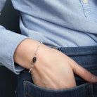 Close up of person wearing an aquamarine and kyanite bracelet