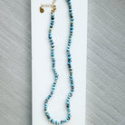 Necklace with Golden Hills turquoise beads on a white dish against a gray background