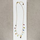 Multicolored gemstone necklace on a white background