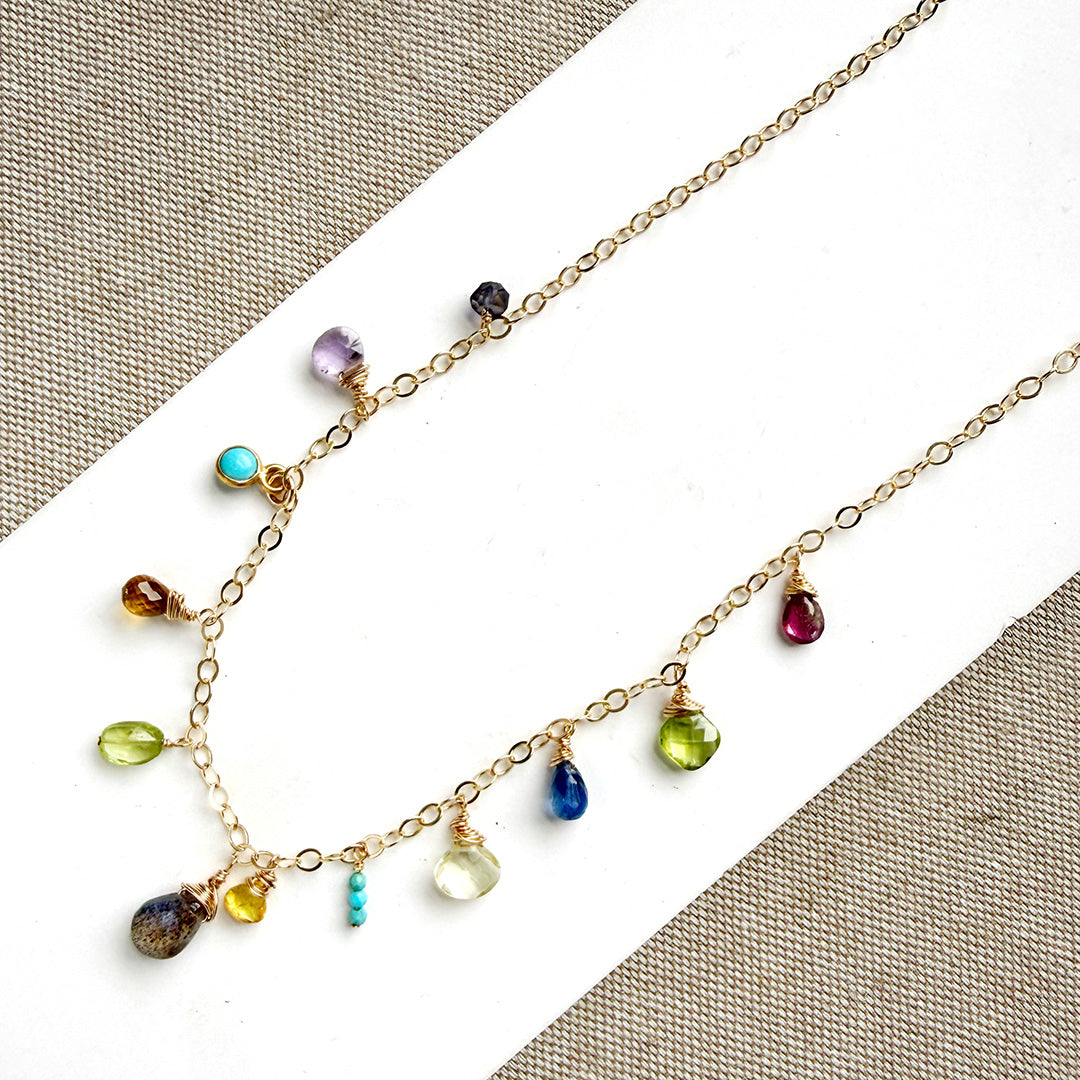 Multicolored gemstone necklace on a white background