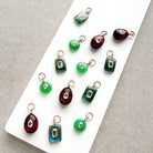 Multiple gemstone charms with inset cz stones on  white tray