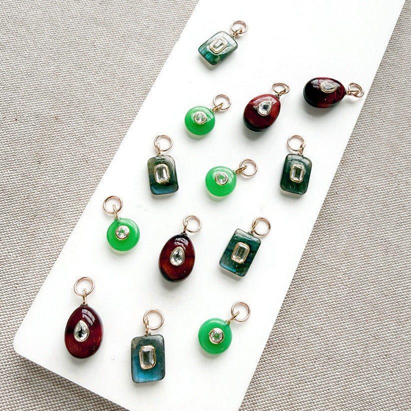 Multiple gemstone charms with inset cz stones on  white tray