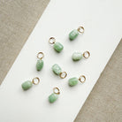 Jade charms in a cylinder cut on a white plate
