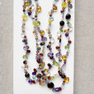 Colorful gemstone necklace on a light background