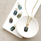 Rectangular labradorite charm with inset cz stone in a white dish