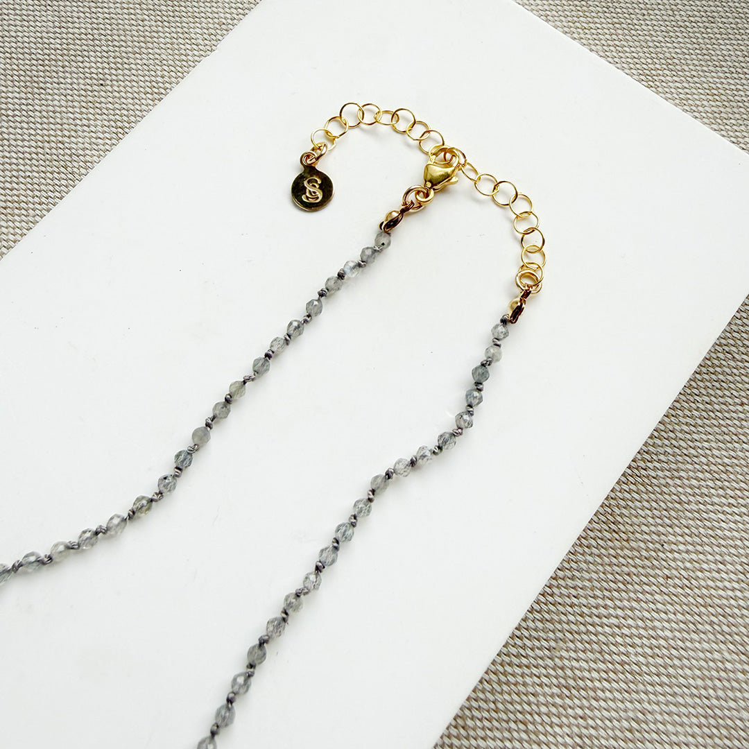 Necklace with small labradorite gemstones on a white background