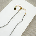 Necklace with small labradorite gemstones on a white background