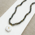 Knotted labradorite necklace with flower shaped carved mother of pearl pendant