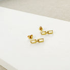 Chain link stud in gold on a white background