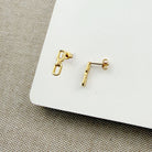 Chain link stud in gold on a white background