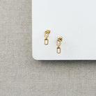 Chain link stud in gold on a white background