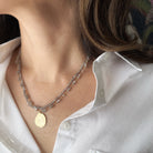 Layered labradorite necklaces with a pendant worn by a person in a white shirt