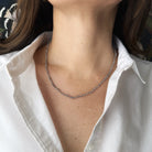 Labradorite necklace on a person wearing a white shirt