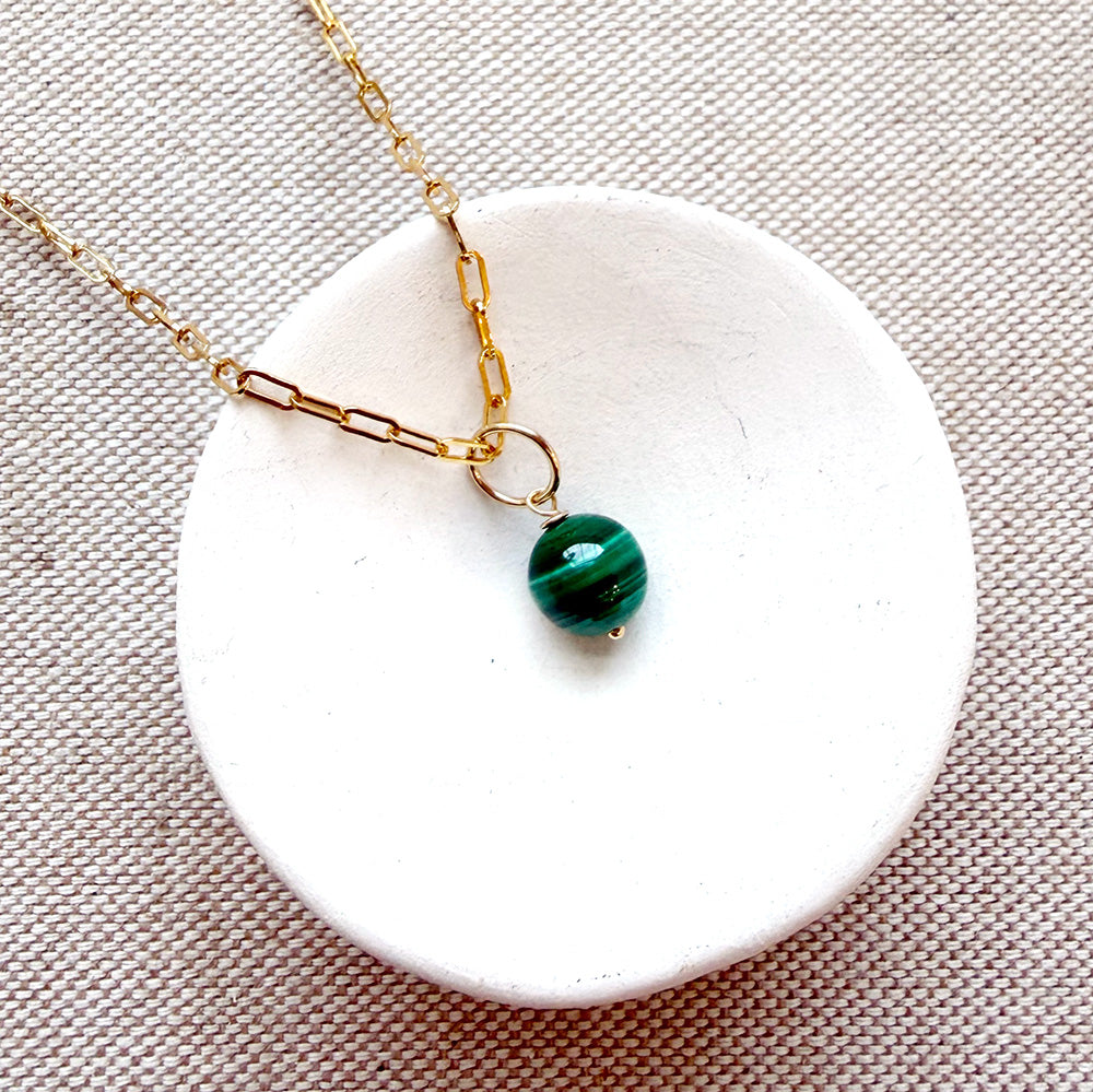 Dish with small round malachite gem charm on a chain