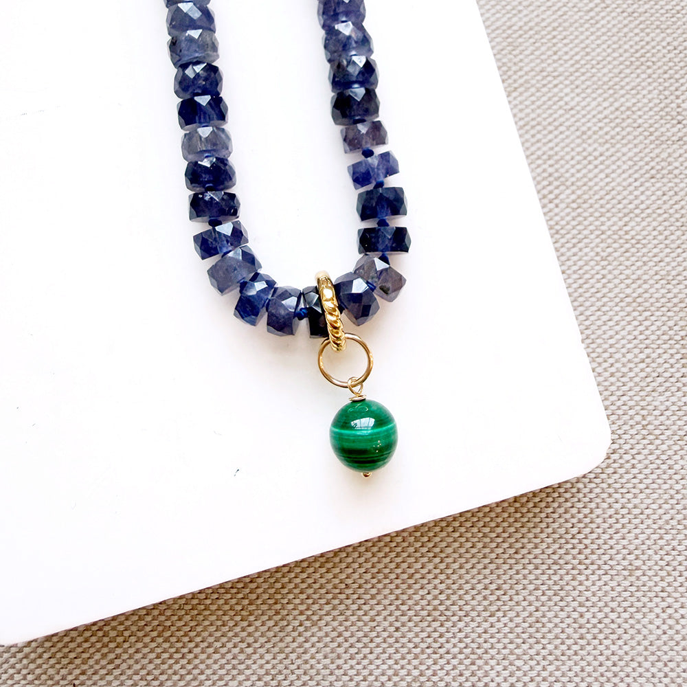 Dish with small round malachite gem charm on a gemstone strand