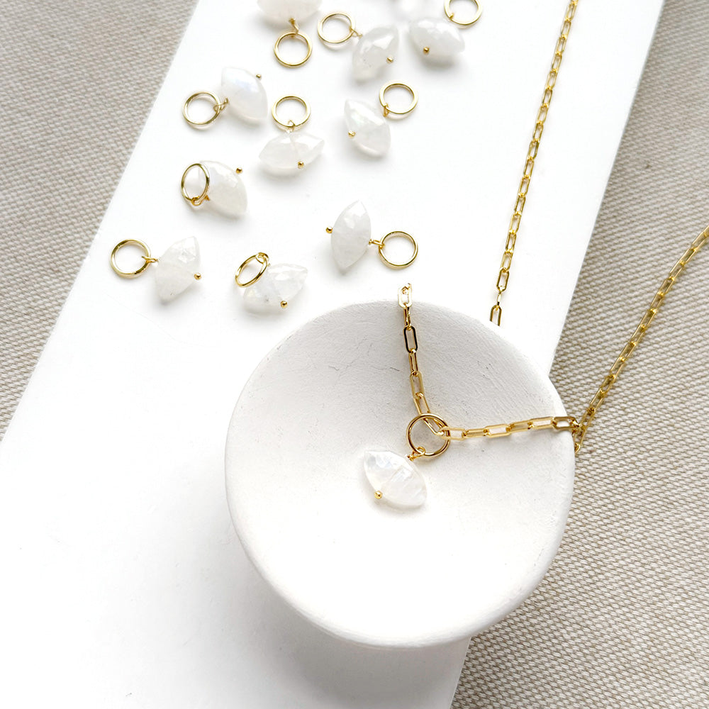 Marquis cut white moonstone charm on a white background