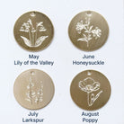 Discs showing birth flowers for May through August