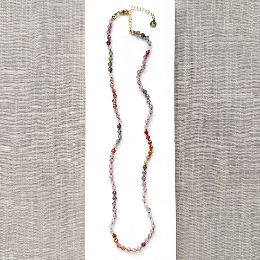 Spinel knotted necklace on a white plate