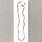 Spinel knotted necklace on a white plate