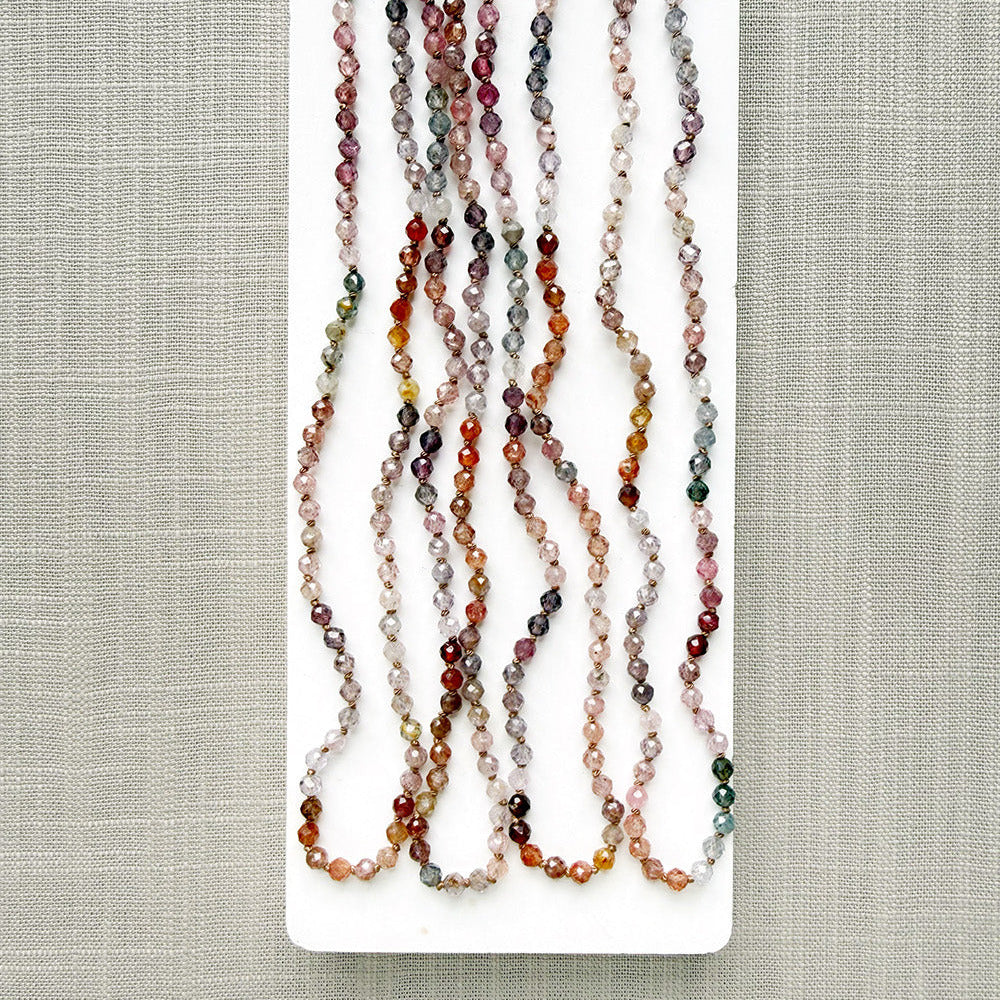 Spinel knotted necklace on a white plate