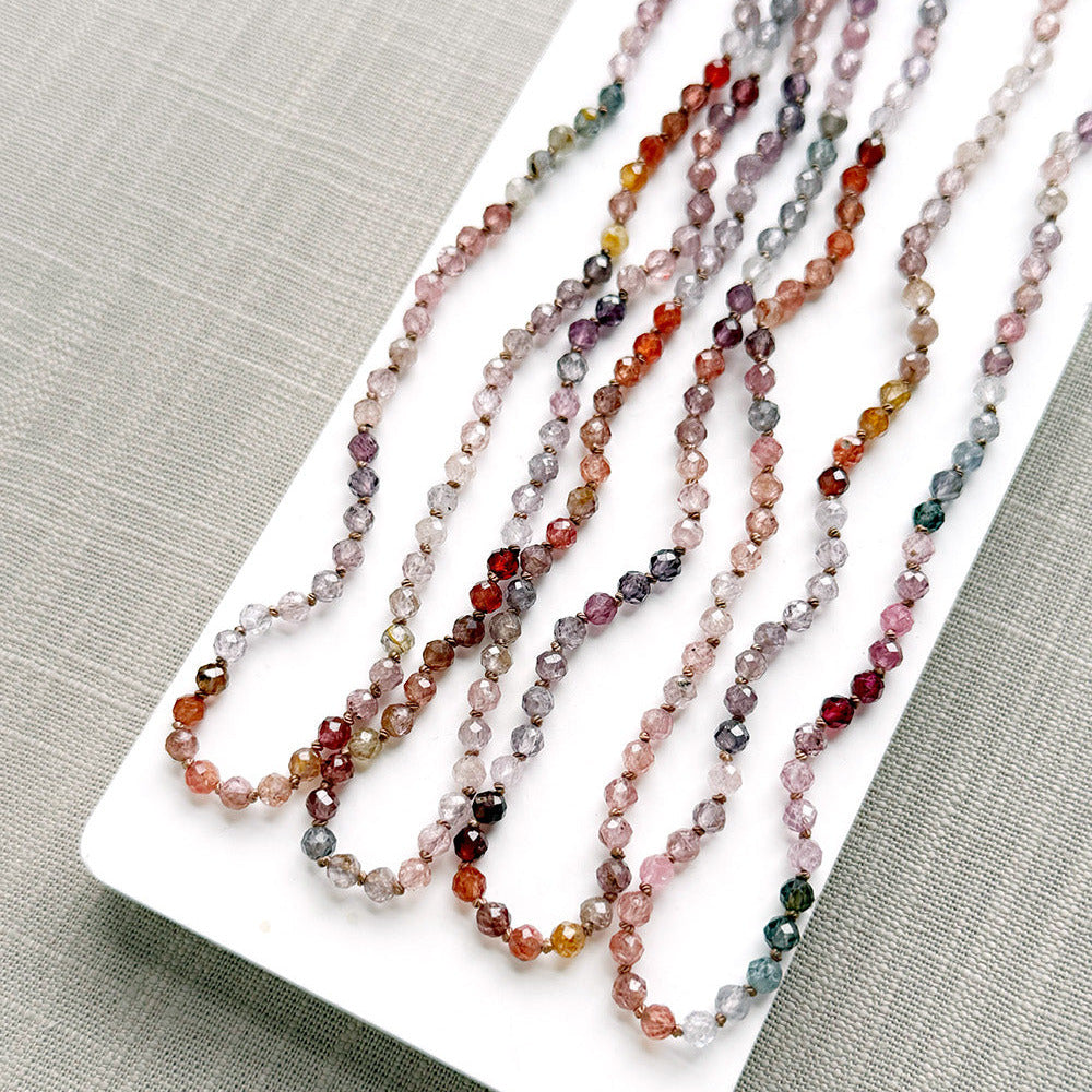 Spinel knotted necklaces on a white plate