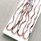 Spinel knotted necklaces on a white plate