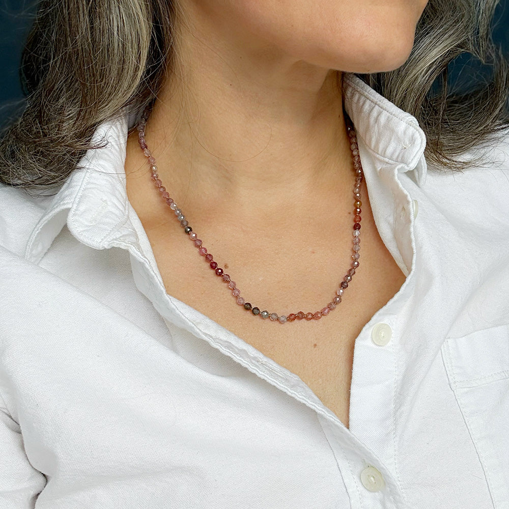 Woman wearing white shirt with a knotted spinel necklace