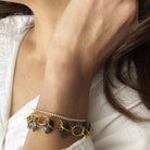 Close up of woman's wrist wearing micro style CZ tennis bracelet stacked with other bracelets