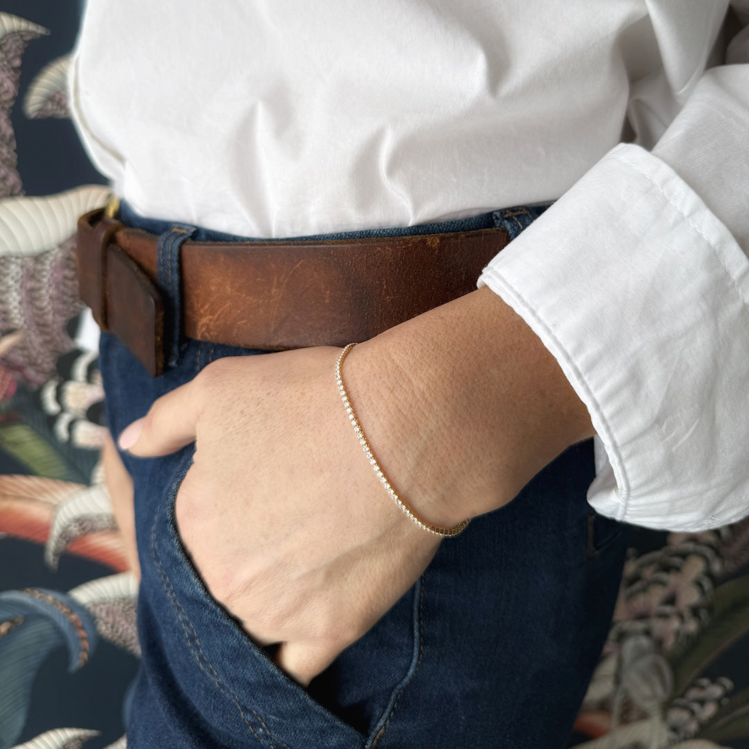 Close up of woman's wrist wearing micro style CZ tennis bracelet