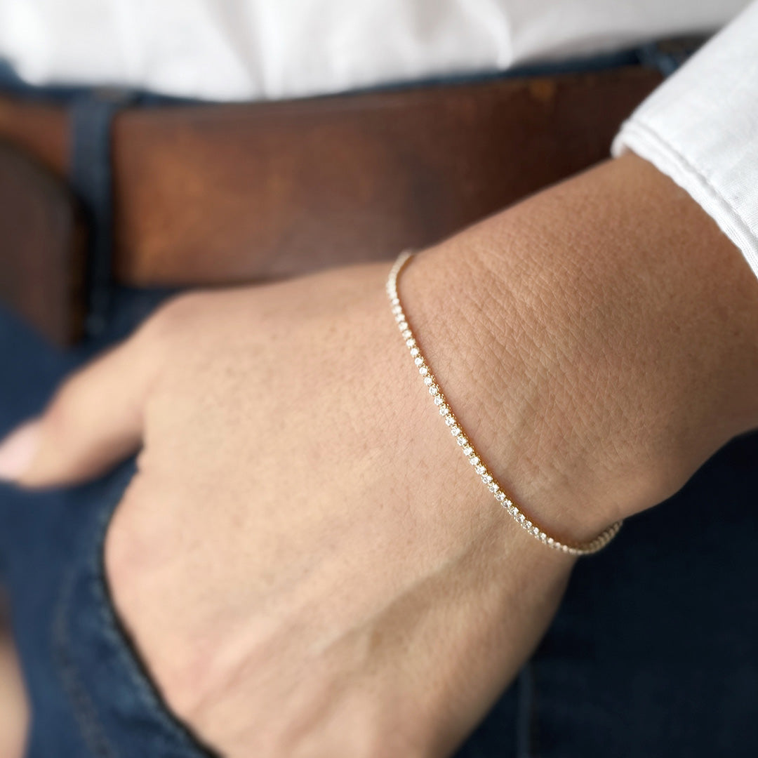 Close up of woman's wrist wearing micro style CZ tennis bracelet