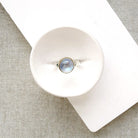 Round moonstone mixed metal ring in a dish