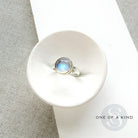 Round moonstone mixed metal ring in a dish