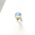 Round moonstone mixed metal ring on a white background